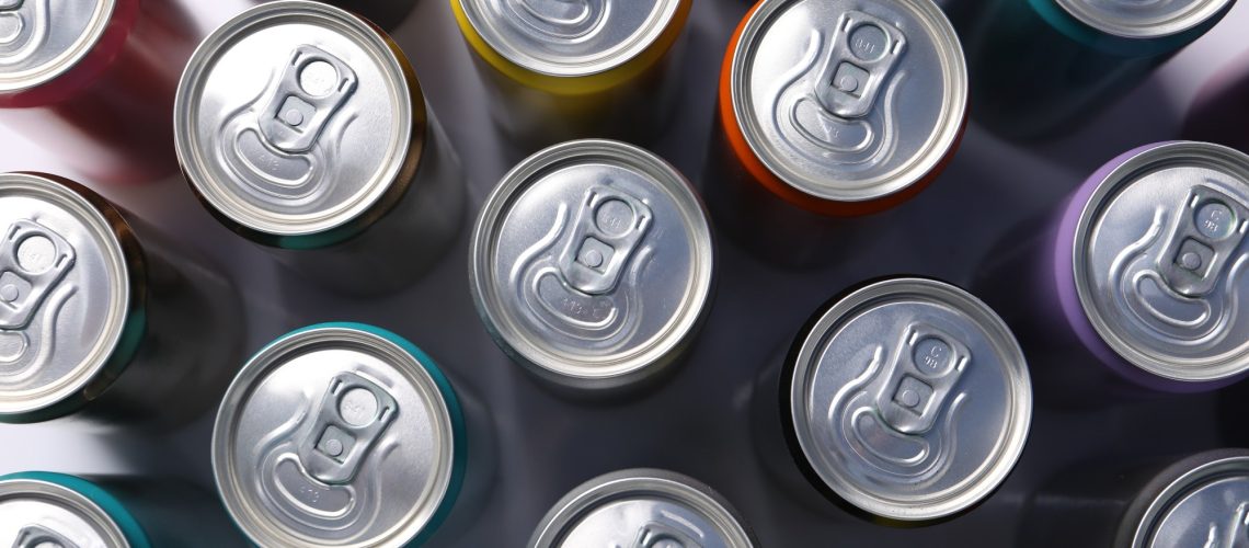 Many aluminium cans of beverage on table, flat lay