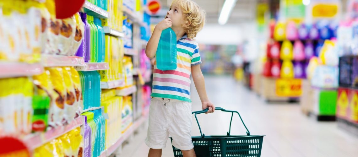 Child in supermarket buying fruit and juice