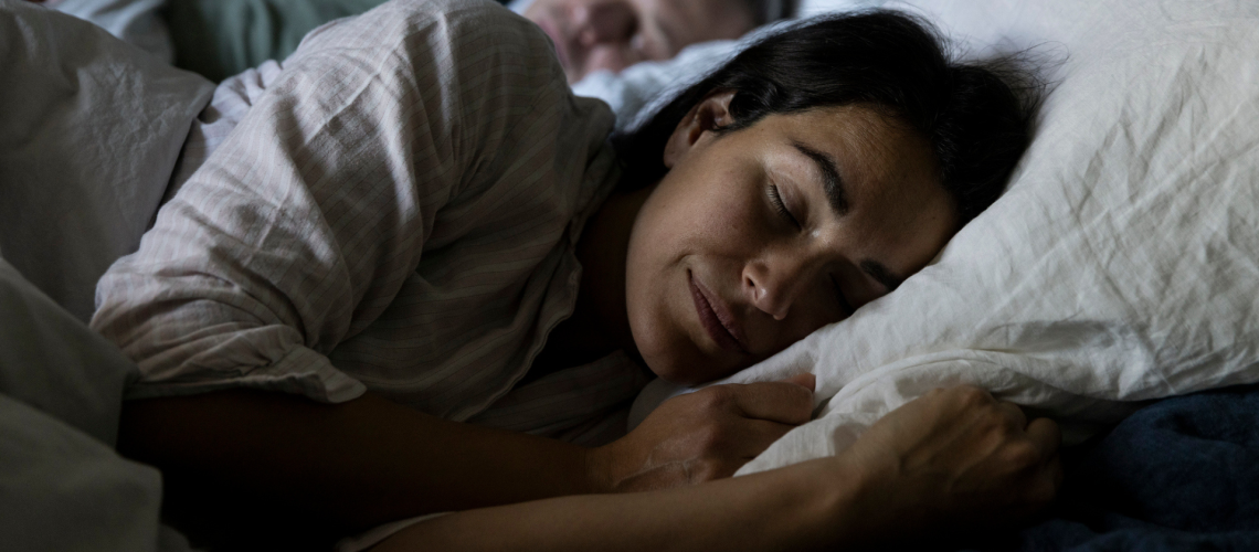 A man and woman sleeping in bed in winter