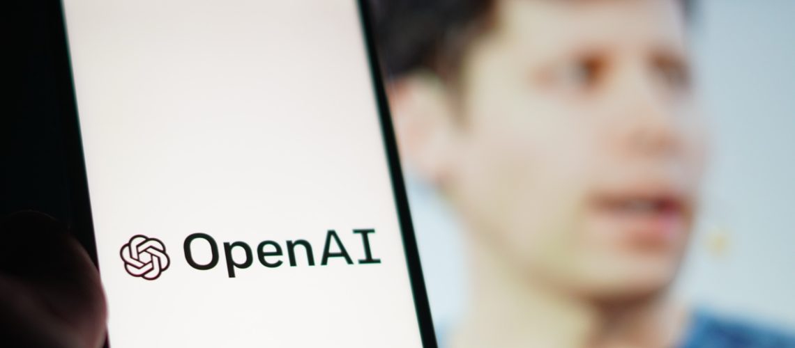 A phone saying OpenAI with Sam Altman behind it