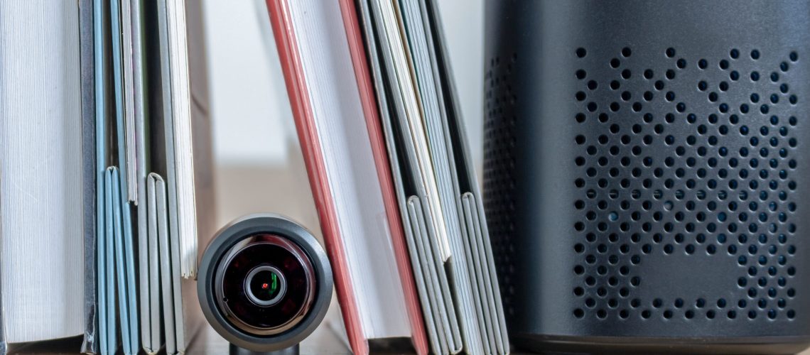 A small security camera hidden in a bookshelf