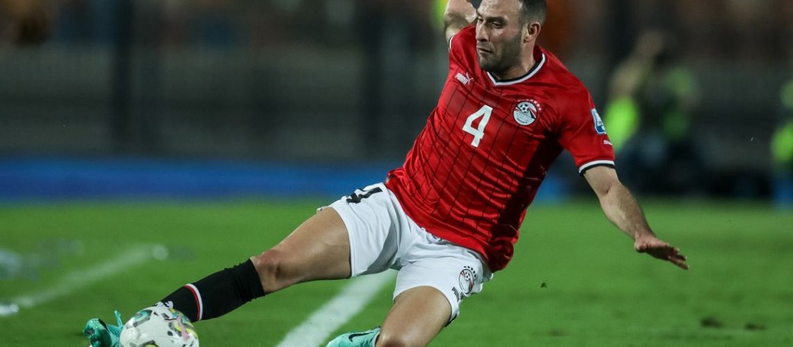 Omar Kamal of Egypt slides towards the ball on a green soccer pitch ahead of the AFCON Egypt vs Mozambique live stream.