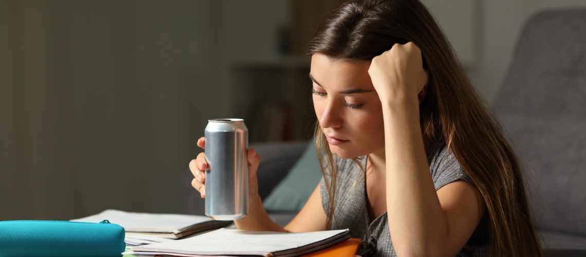 Student studying and drinking an energy drink