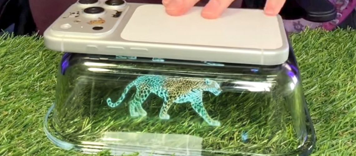 Screenshot of TikTok video showing DIY hologram projector using your phone and a rectangular glass dish.