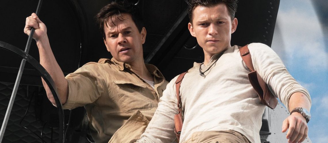 Mark Wahlberg stars as Victor “Sully” Sullivan and Tom Holland is Nathan Drake — both seen staring out of a helicopter —in Columbia Pictures