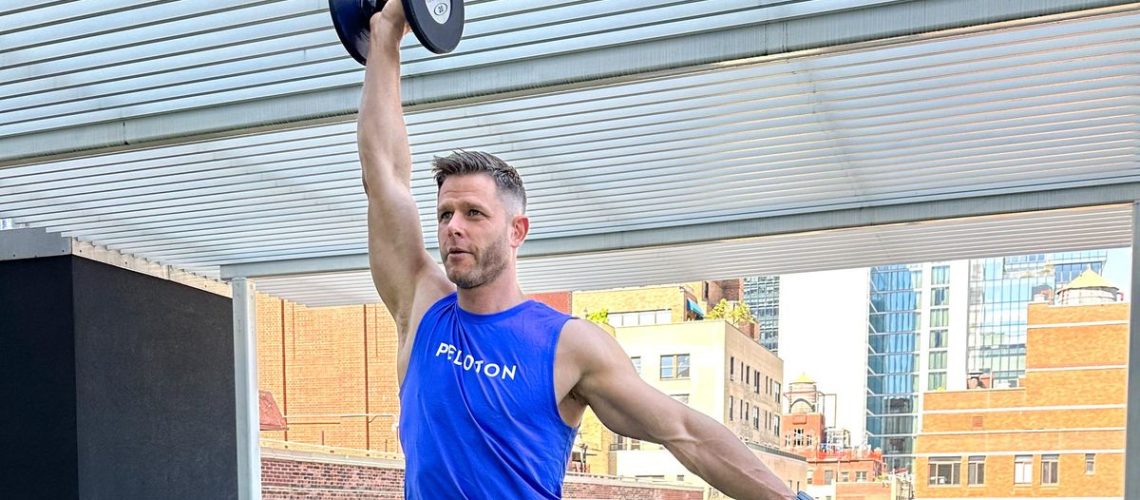 Andy Speer performing a dumbbell overhead press