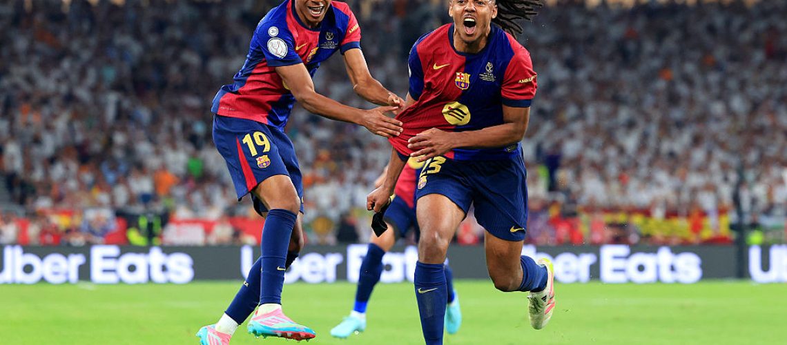 Jules Kounde of FC Barcelona celebrates scoring his team's third goal with Lamine Yamal during the Copa del Rey Final match between FC Barcelona and Real Madrid in April 2025