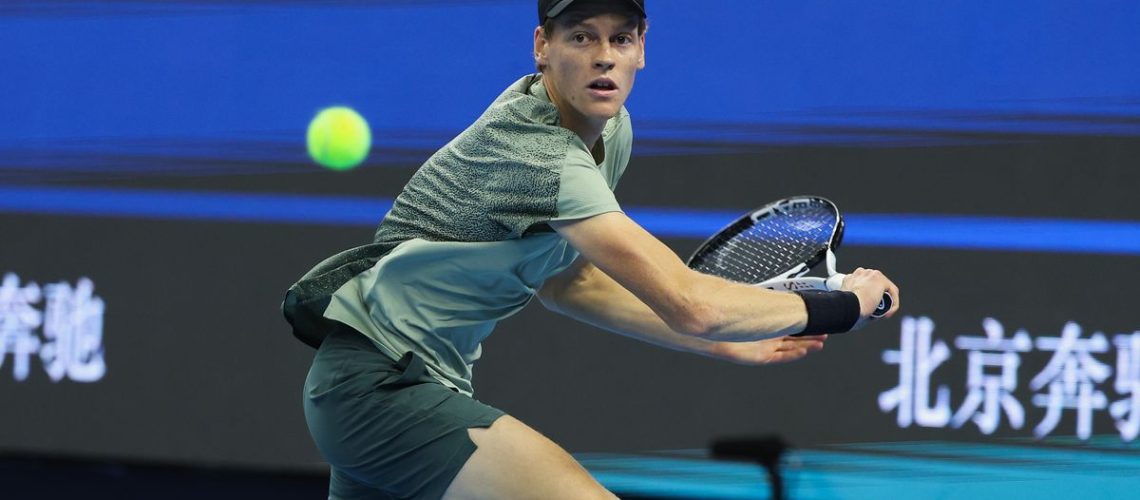 Jannik Sinner of Italy, wearing black nike cap and green shirt, returns a shot ahead of the 2024 Shanghai Masters tennis event