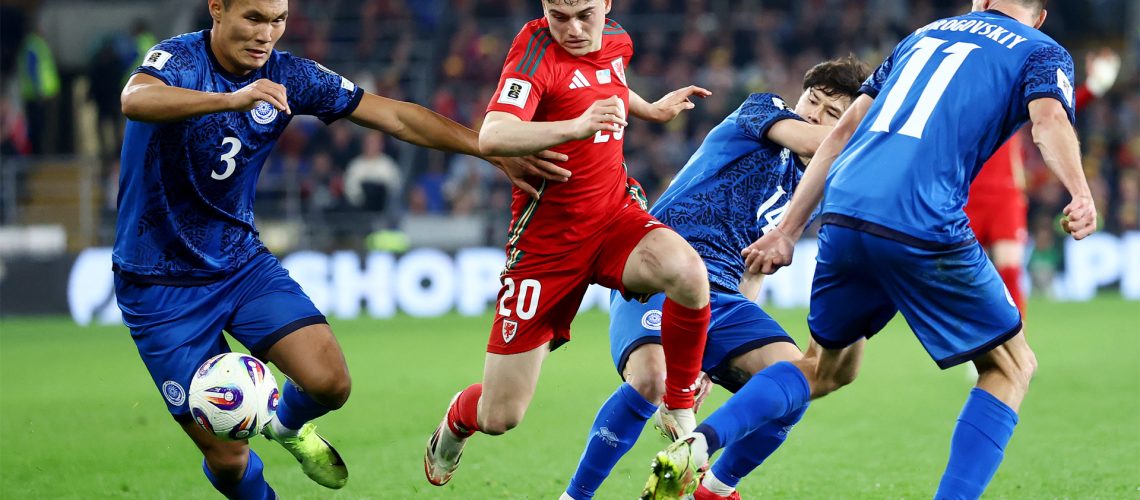 Wales' Daniel James attempts to win the ball from Kazakhstan's Nuraly Alip during the March 2025 World Cup qualifier.