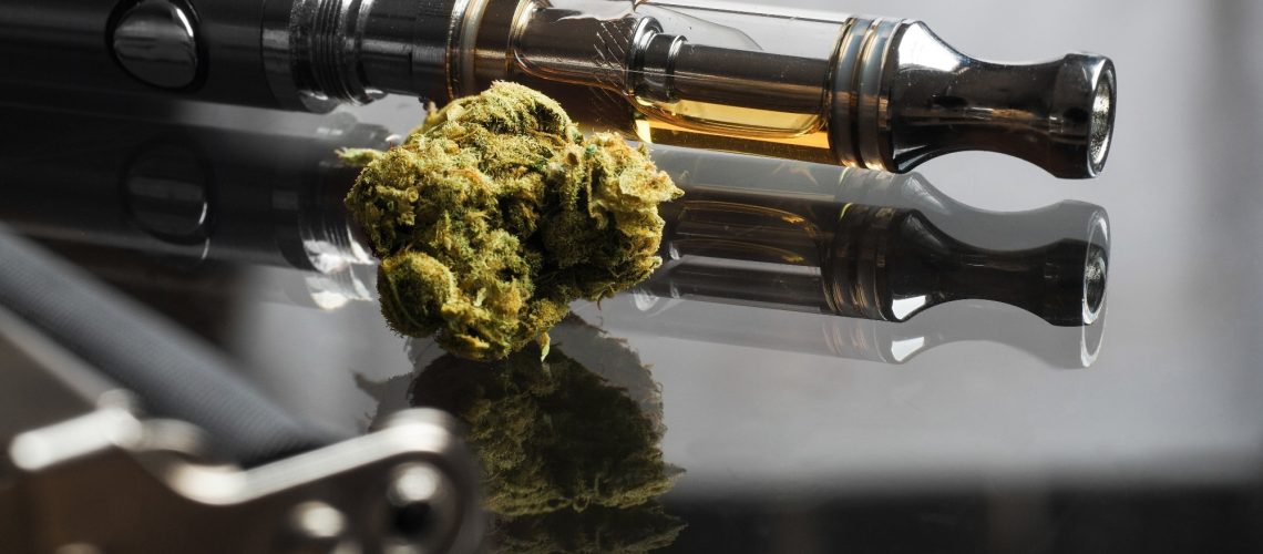 Close up shot focus stack of real cannabis or weed and vape pen in the background