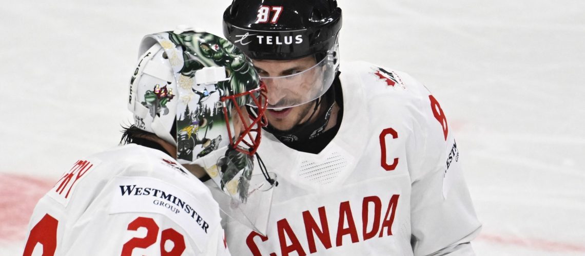 Canada's forward Sidney Crosby and Canada's goalkeeper Marc-Andre Fleury consult after winning the IIHF Ice Hockey World Championship group A match against Latvia ahead of the Canada vs France match on May 13, 2025.