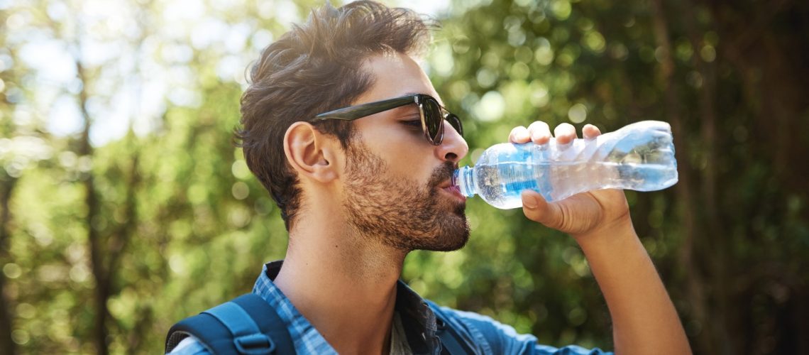 young man stopping for a drink of water