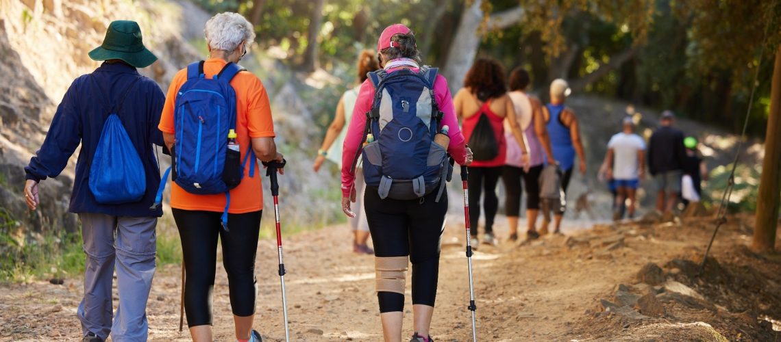 older adults hiking in the forest