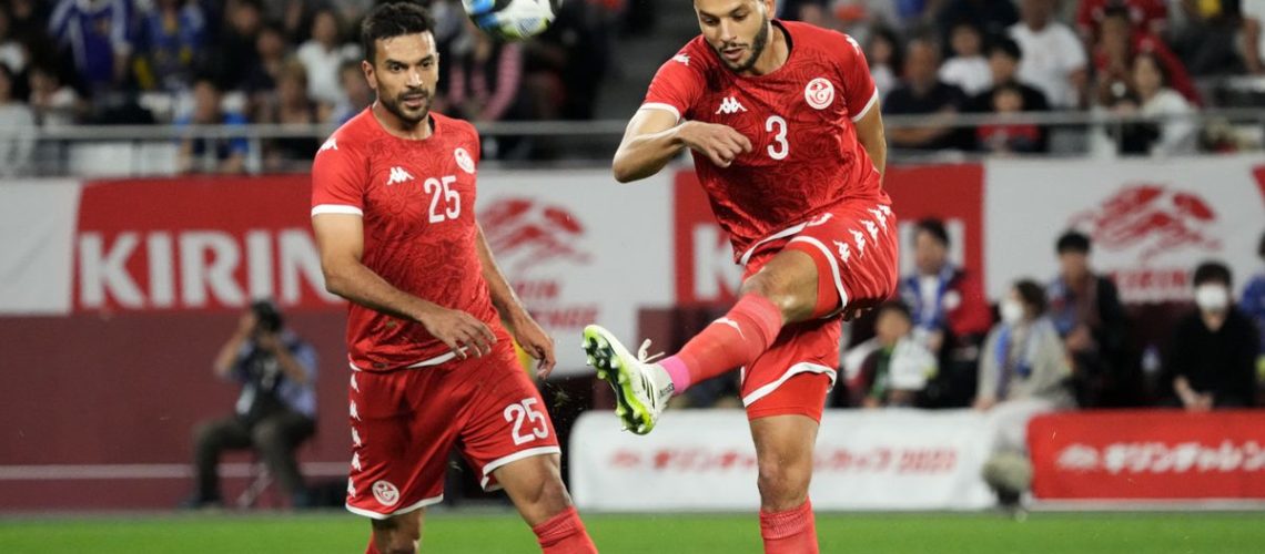 Omar Montassar (R) clears the ball ahead of the Tunisia vs Namibia live stream