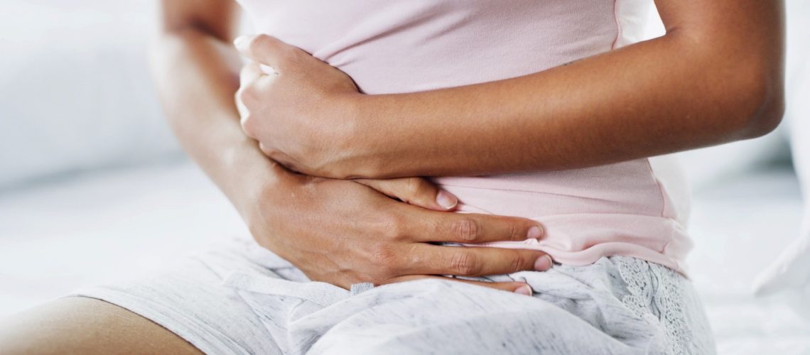 Woman, hands and sick in bed with stomach pain