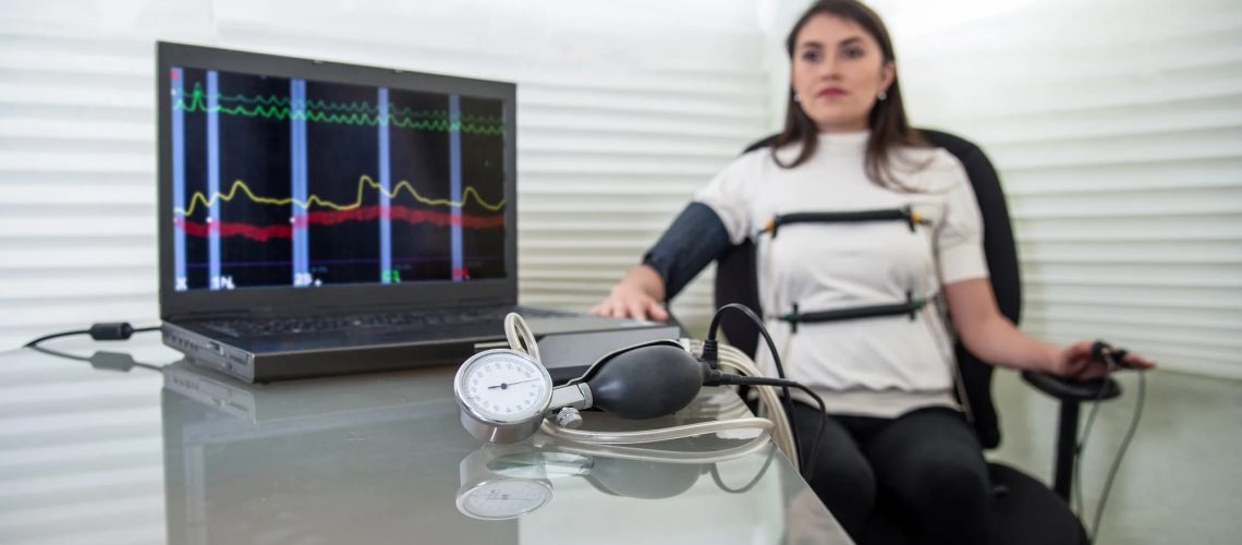 woman in polygraph test with measuring devices to know the truth, scales, hoses and measuring tubes on her body